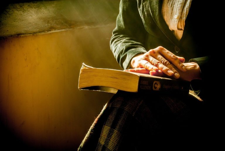 Person Reading Book in Lap